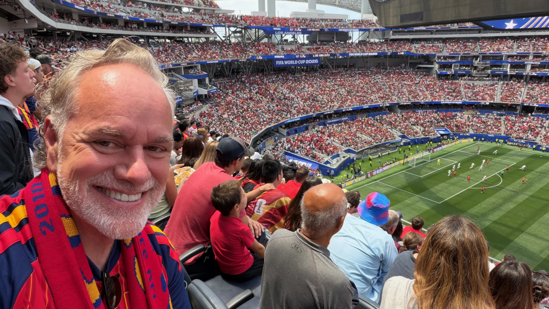 Tony Sarsam at a sold-out SoFi Stadium in Los Angeles during a FIFA World Cup 2026 match, Spain vs Austria, stands filled with fans in red behind him